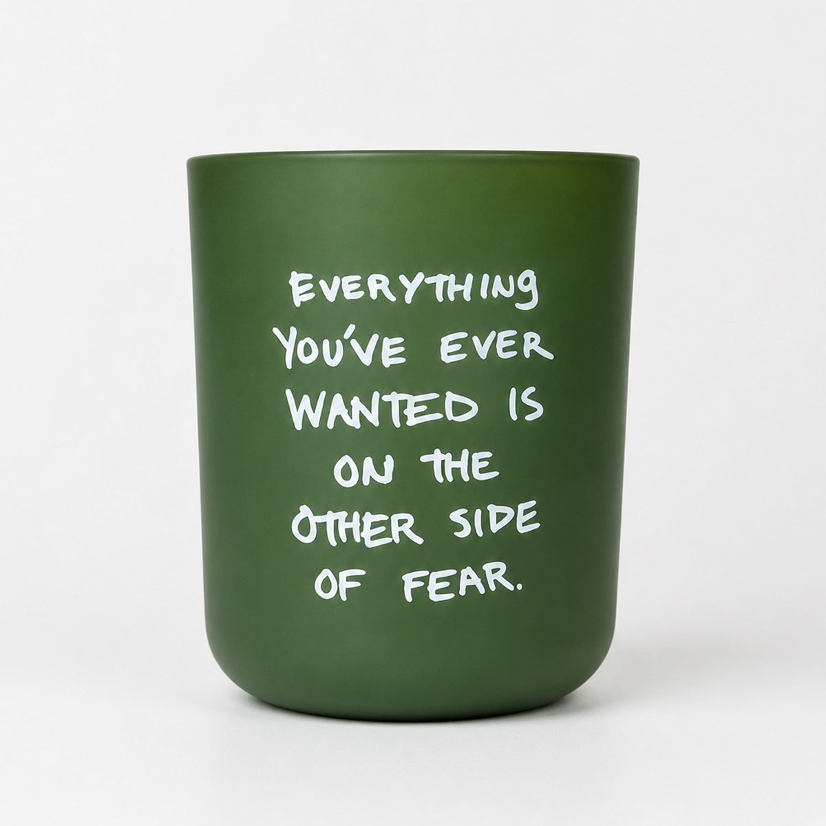 KASE Candle in a frosted green glass vessel reading Everything you’ve ever wanted is on the other side of fear